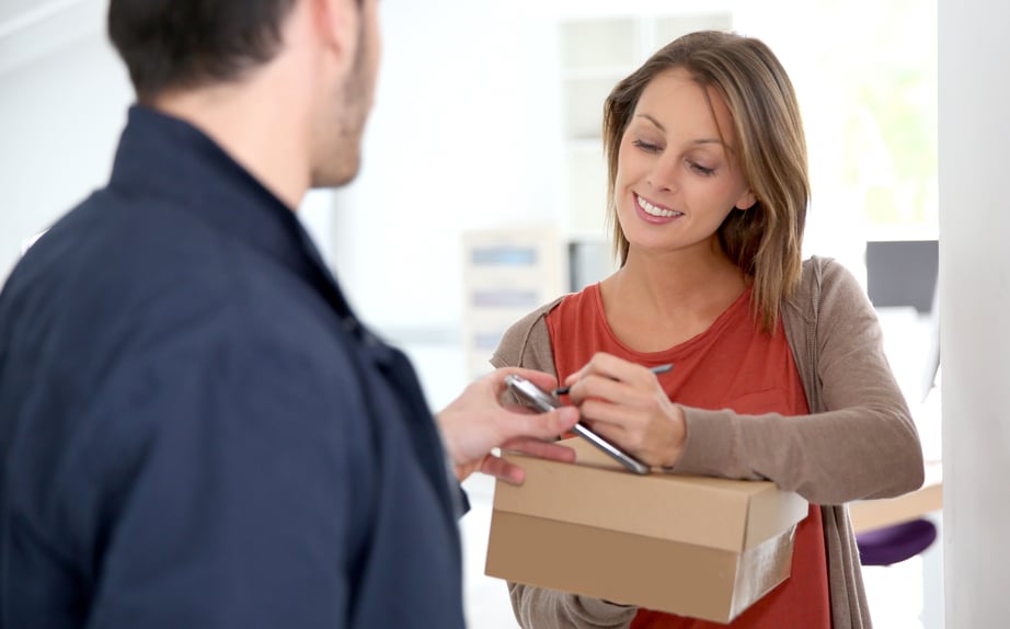 Woman sigining electronic receipt of delivered package-1